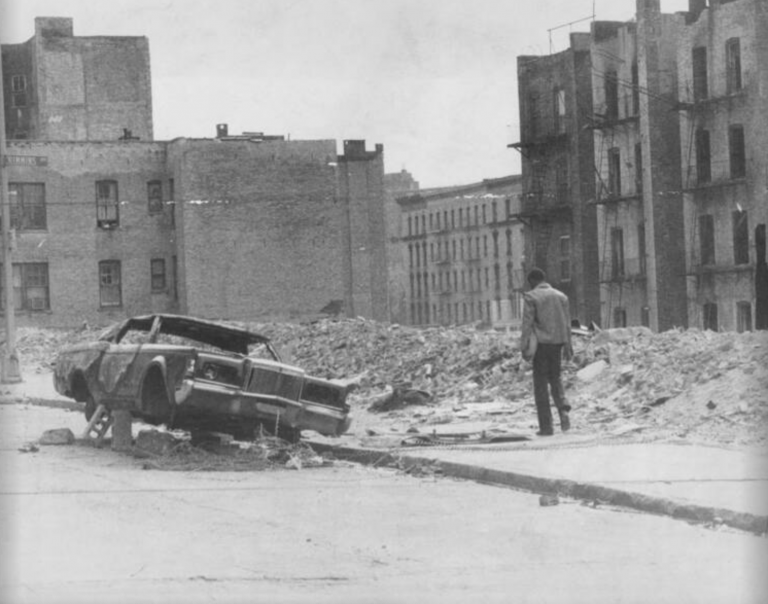 Photo of a man walking on a burnt-down section of Crimmins Avenue