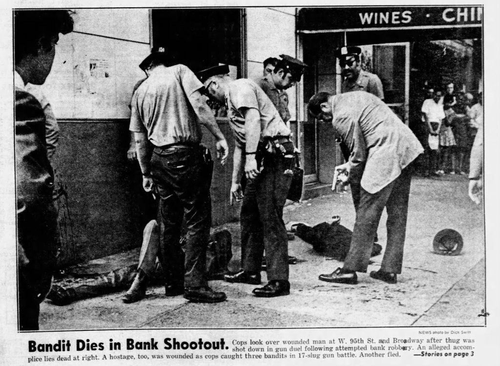 NY Daily News clipping of photo from aftermath of bank robbery, showing police officers leaning over body of dead bank robber.